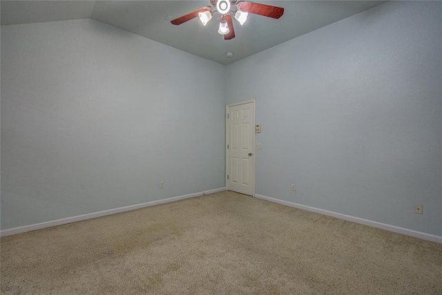 empty room featuring lofted ceiling, carpet floors, and ceiling fan