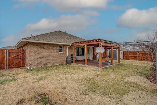 rear view of property with a storage shed, a yard, and a patio area