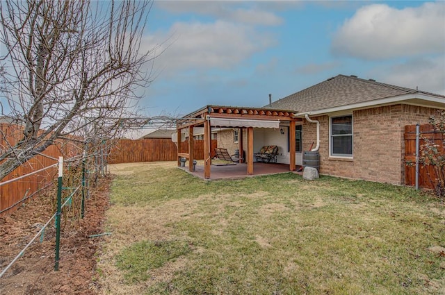 rear view of house featuring a yard and a patio