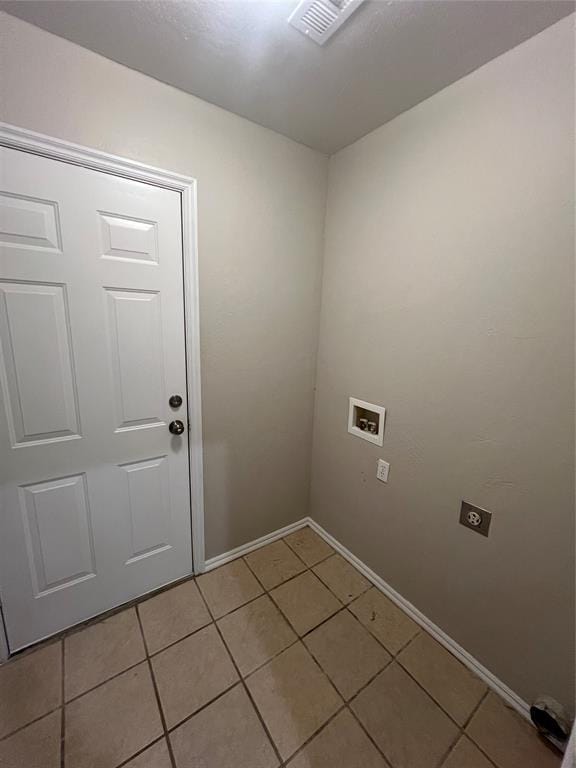 clothes washing area featuring electric dryer hookup, light tile patterned floors, and hookup for a washing machine