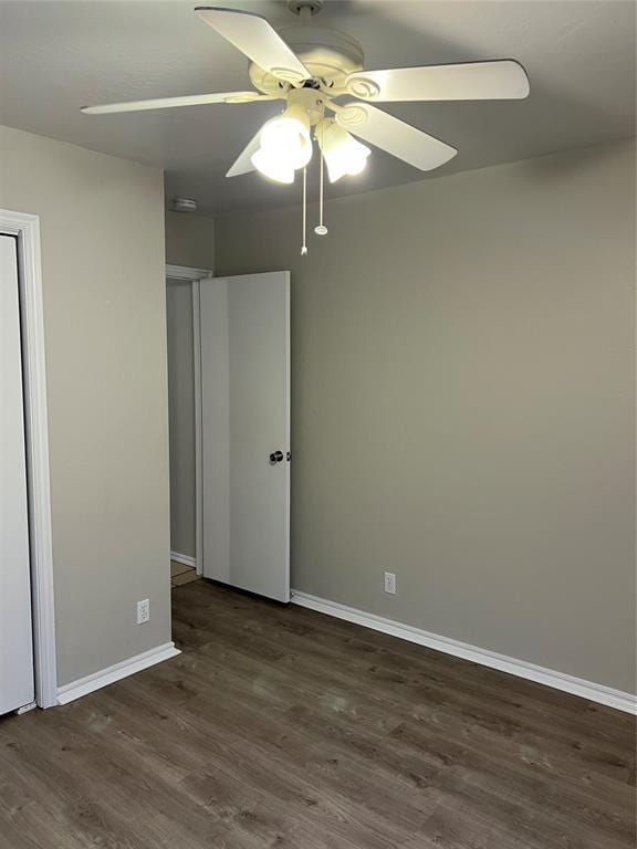 unfurnished bedroom with dark hardwood / wood-style floors and ceiling fan