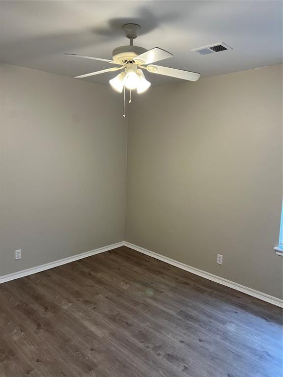 spare room with dark hardwood / wood-style floors and ceiling fan