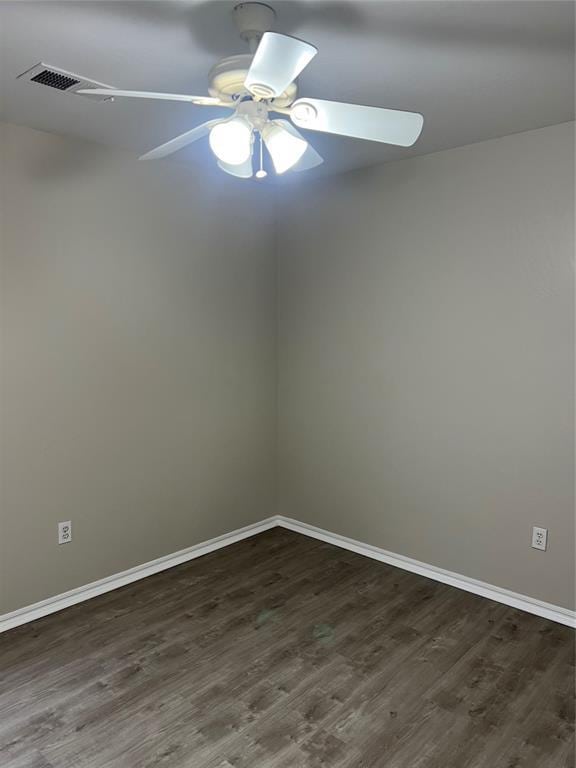 spare room with ceiling fan and dark hardwood / wood-style flooring