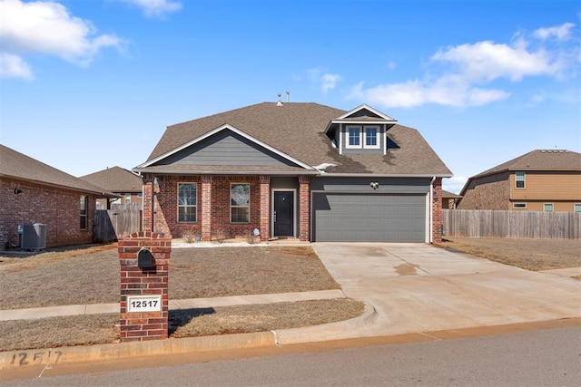 view of front of house featuring a garage and central AC