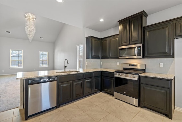 kitchen featuring light carpet, appliances with stainless steel finishes, sink, and decorative backsplash