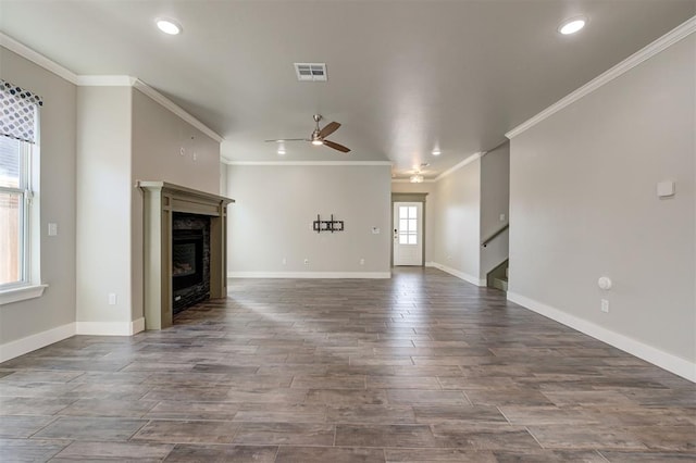 unfurnished living room featuring crown molding, dark wood-type flooring, and ceiling fan