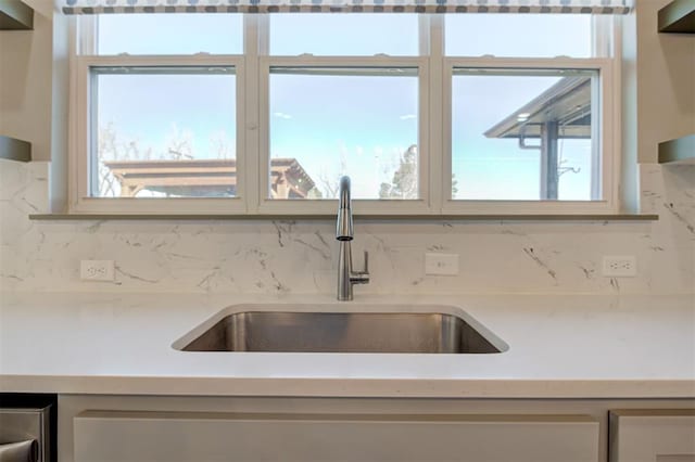 kitchen featuring tasteful backsplash and sink