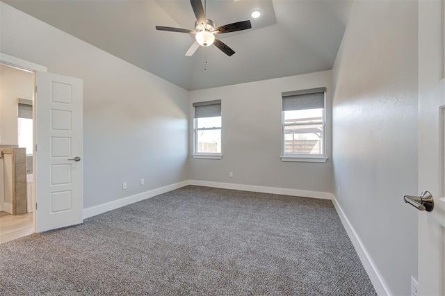 unfurnished room with lofted ceiling, ceiling fan, and carpet flooring