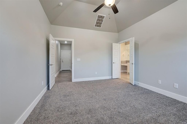 unfurnished bedroom with ceiling fan, light carpet, and high vaulted ceiling