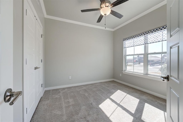 unfurnished bedroom with ornamental molding, light colored carpet, and ceiling fan