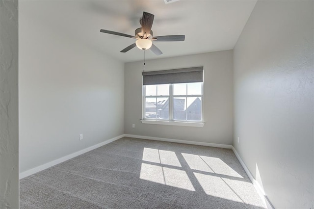 unfurnished room featuring light carpet and ceiling fan