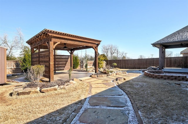 view of yard featuring ceiling fan and a patio area