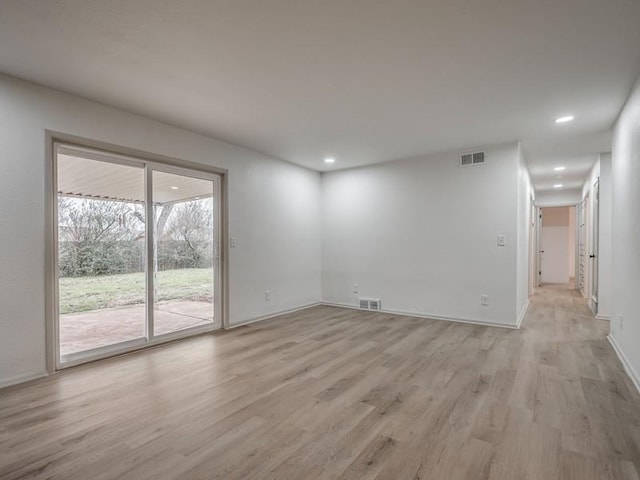 spare room with light hardwood / wood-style floors