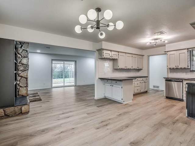 kitchen with dishwasher, backsplash, a chandelier, and light hardwood / wood-style flooring