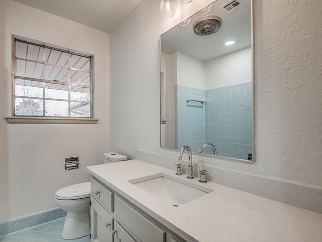 bathroom with vanity, tile patterned floors, and toilet