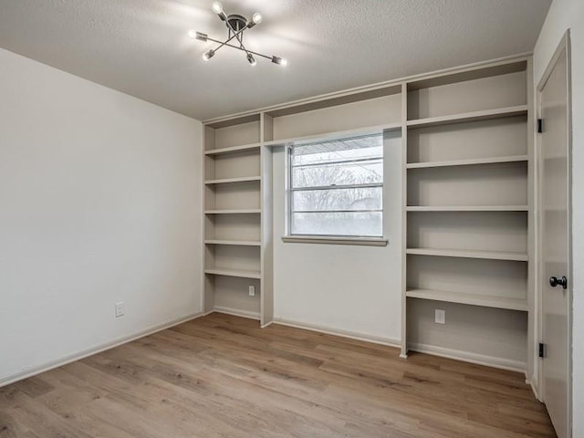 unfurnished bedroom featuring hardwood / wood-style flooring, a closet, and a textured ceiling