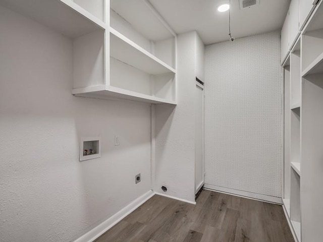 clothes washing area with electric dryer hookup, dark hardwood / wood-style floors, and washer hookup