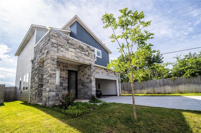 view of front of home with a garage and a front lawn