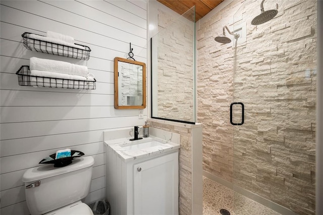 bathroom featuring a shower stall, toilet, vanity, and wooden ceiling