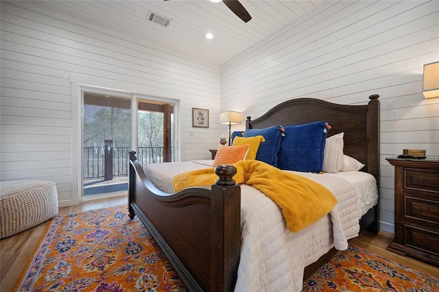 bedroom featuring access to outside, wood finished floors, wood walls, recessed lighting, and wood ceiling