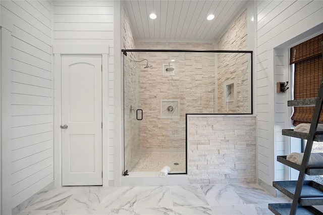 bathroom featuring recessed lighting, a shower stall, and marble look tile flooring