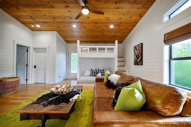 living area featuring wood ceiling, wooden walls, ceiling fan, wood finished floors, and vaulted ceiling