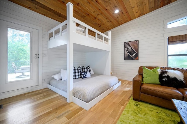 bedroom with wood walls, wooden ceiling, wood finished floors, lofted ceiling, and recessed lighting