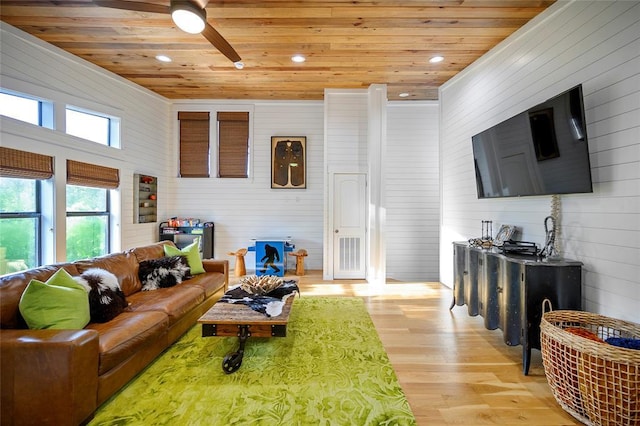 living area featuring wood ceiling, light wood-type flooring, recessed lighting, a ceiling fan, and wood walls