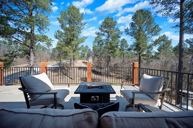 view of patio / terrace featuring an outdoor living space with a fire pit