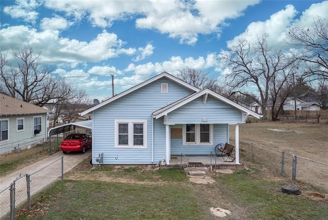 view of front of property with a front lawn, a carport, and a porch