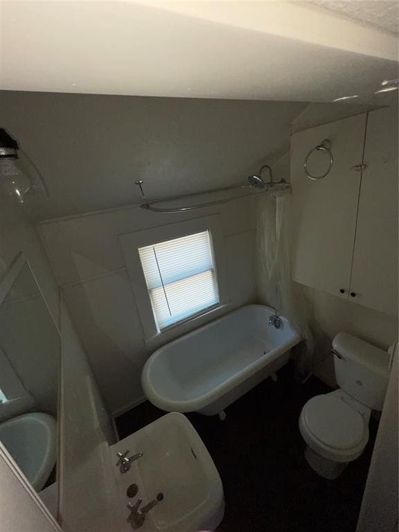 bathroom with toilet and bathing tub / shower combination