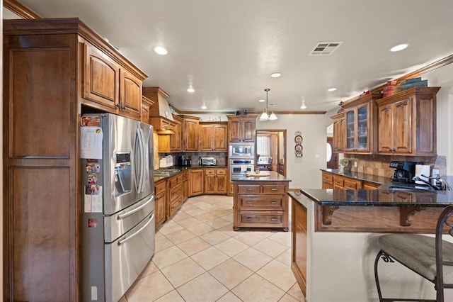 329826 E Hwy 66, Wellston, OK 74881 - kitchen featuring stainless steel appliances, a peninsula, brown cabinetry, tasteful backsplash, and recessed lighting