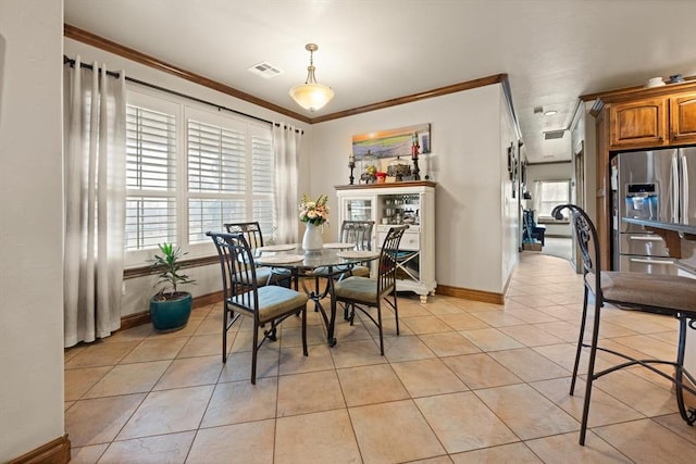 329826 E Hwy 66, Wellston, OK 74881 - dining space with healthy amount of natural light, crown molding, light tile patterned floors, and baseboards