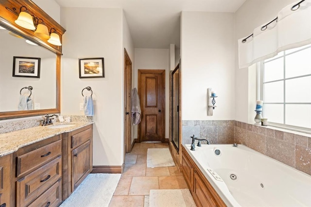 329826 E Hwy 66, Wellston, OK 74881 - bathroom featuring a whirlpool tub, vanity, baseboards, and stone tile floors