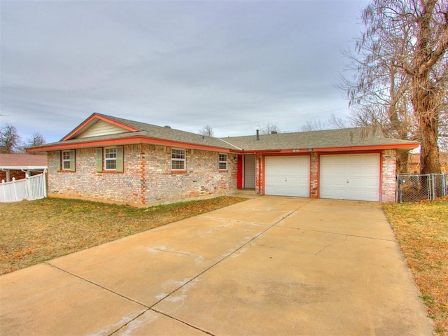 ranch-style house featuring a garage and a front lawn