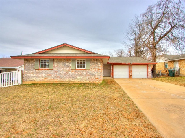 ranch-style home featuring a garage and a front yard