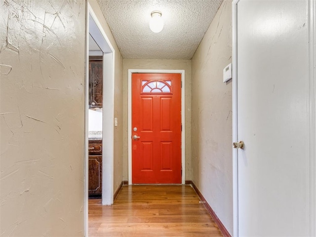 entryway featuring a textured ceiling and light wood-type flooring