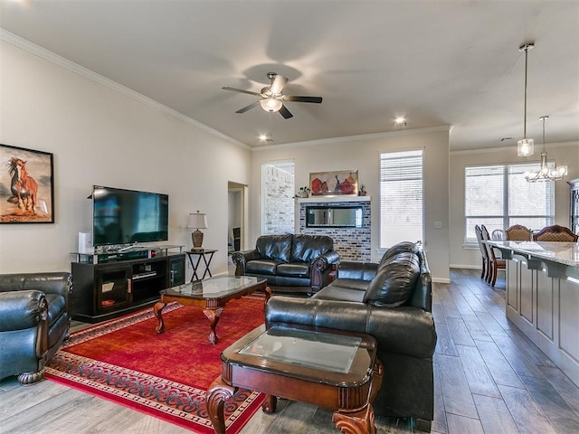 3683 King Arthur Ct, Newcastle, OK 73065 - living room featuring ornamental molding, ceiling fan, wood finished floors, baseboards, and a chandelier
