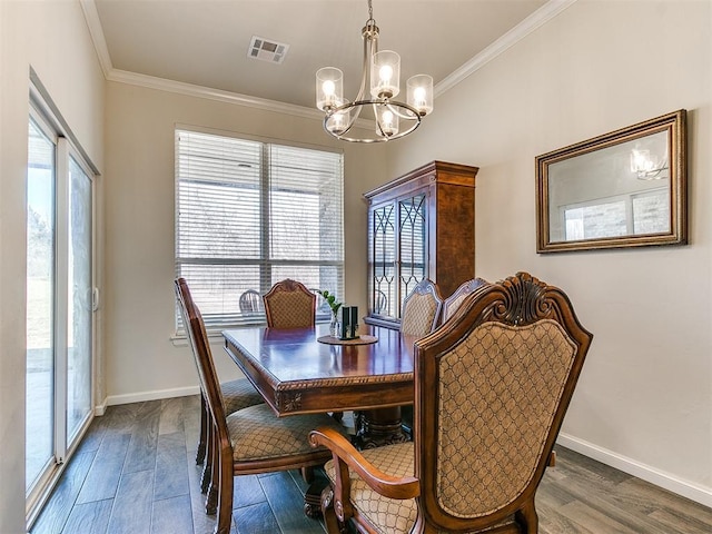 3683 King Arthur Ct, Newcastle, OK 73065 - dining area with a chandelier, ornamental molding, wood finished floors, and baseboards