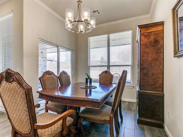 3683 King Arthur Ct, Newcastle, OK 73065 - dining area with a chandelier, baseboards, wood finished floors, and ornamental molding