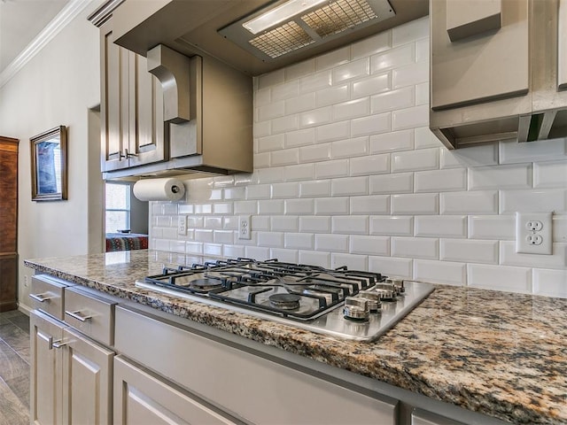 3683 King Arthur Ct, Newcastle, OK 73065 - kitchen featuring stainless steel gas cooktop, backsplash, ornamental molding, baseboards, and light stone counters
