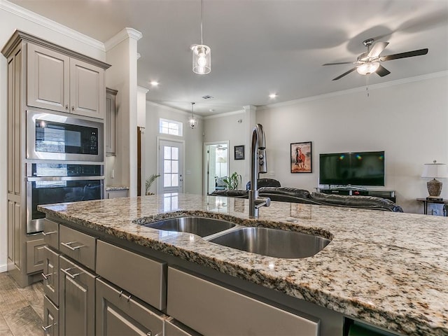 3683 King Arthur Ct, Newcastle, OK 73065 - kitchen featuring oven, built in microwave, ornamental molding, a sink, and open floor plan