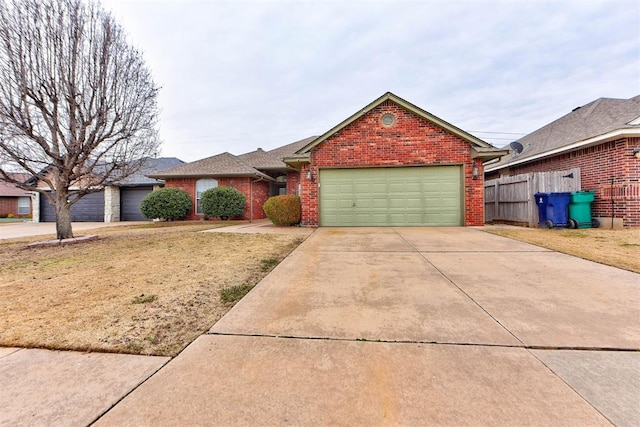 single story home featuring a garage and a front lawn