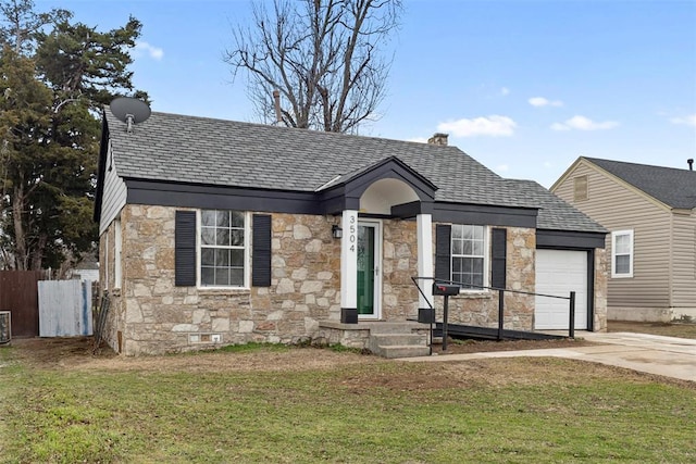 view of front of property with a garage and a front lawn