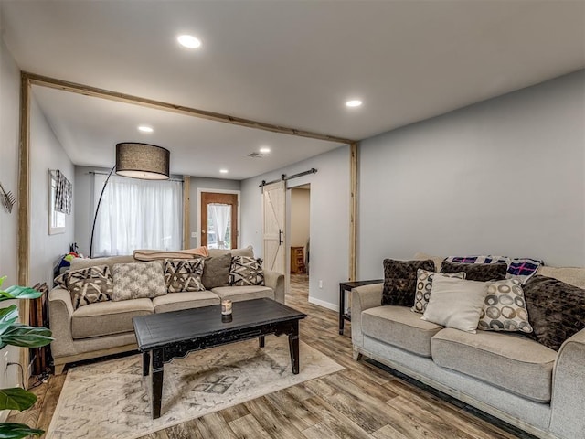 living room featuring hardwood / wood-style flooring and a barn door