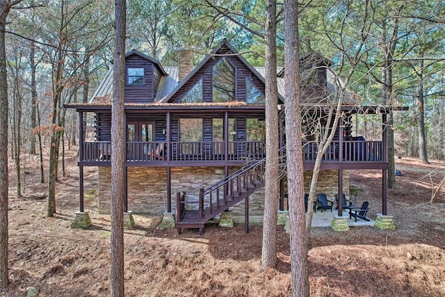 back of property with a patio area and a deck