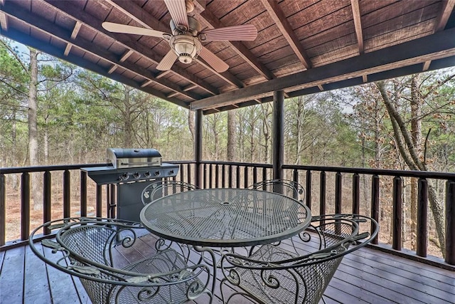 wooden deck featuring ceiling fan and a grill