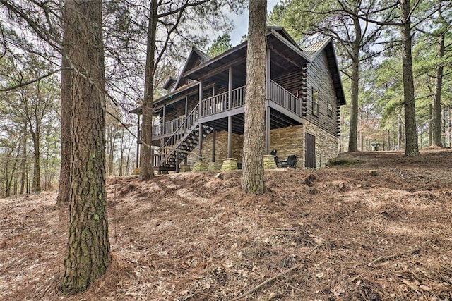 rear view of property with a wooden deck