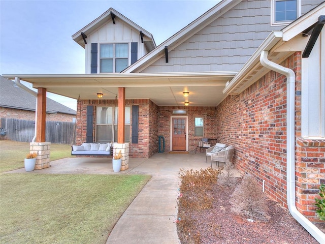 entrance to property with a yard and a patio area