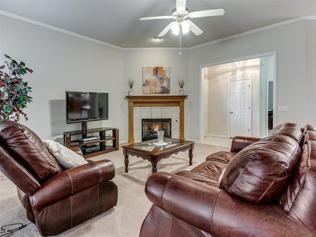 carpeted living room with ceiling fan, ornamental molding, and a fireplace